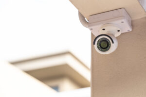 White CCTV camera secured to a wall