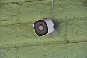 commercial CCTV camera on green wall